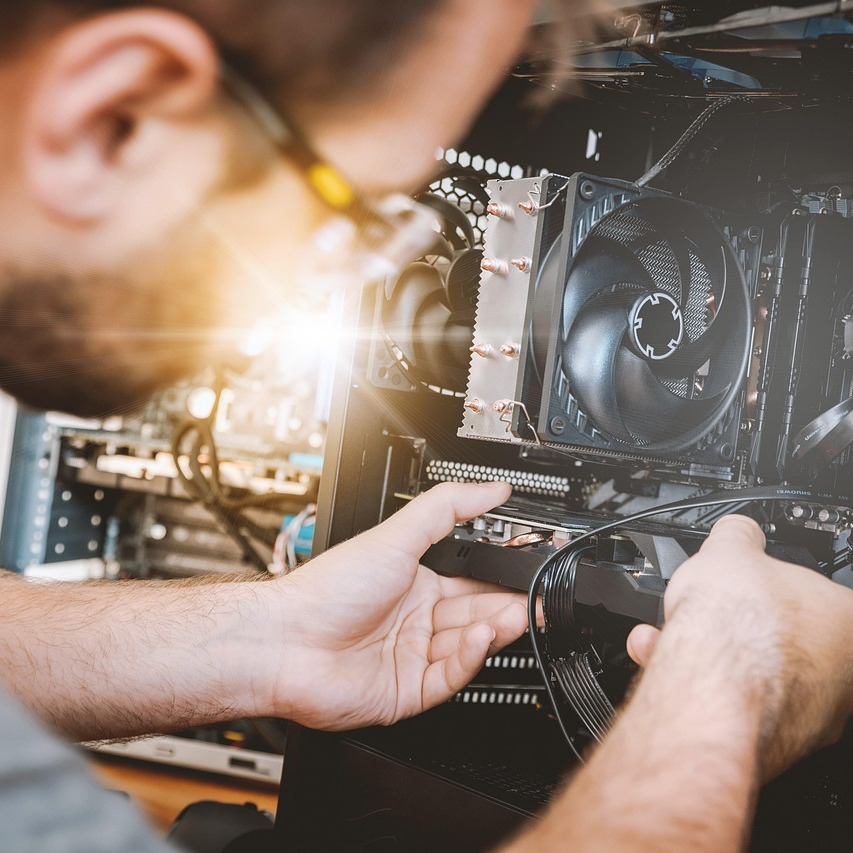 man removing a graphics card from a computer